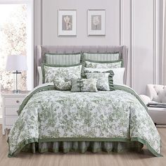 a bed with green and white comforters in a room