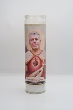 a candle with an image of a man holding a heart