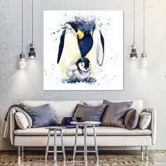 a living room with a couch, table and painting on the wall above it is a penguin holding a baby penguin