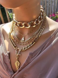 This handmade 24 K gold  plated chain layered multi stand stacked punk goth edgy style necklace set is a stunning piece of jewelry that is perfect for those who love bold and edgy accessories. This is two necklaces, the big chunky choker that is adjustable with a built-in extender from 14" to 17", and the 4-strand drop festoon design necklace (also adjustable 15" to 18"). Adding depth and dimension to the piece is a u lock and spearhead pendant. Very punk, grunge aesthetic! This necklace set is Multi Chain Choker Necklace With Cross, Luxury Double Chain Multi-strand Necklace, Good Necklace Stack, Trendy Multi-strand Chunky Chain Jewelry, Gold Punk Clavicle Chain Necklace, Gold Punk Choker For Gift, Punk Style Gold Choker Gift, Gold Punk Clavicle Chain Jewelry, Punk Gold Choker Jewelry