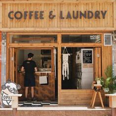 a man standing in the doorway of a coffee and laundry shop