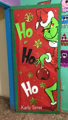 the grinch door is decorated for christmas with santa's helper on it