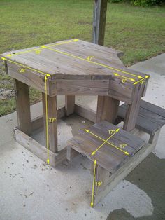 a wooden picnic table sitting on top of a sidewalk