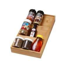 spices and condiments are arranged on a wooden tray