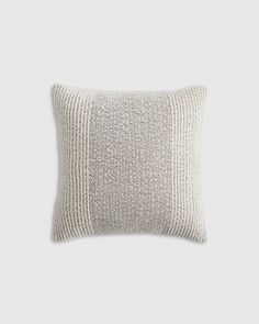 the textured pillow is made from linen and has a white stripe pattern on it