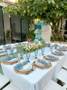 the table is set with blue and white dishes