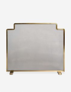 a white and gold fireplace screen on a stand