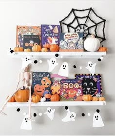 two white shelves filled with books and halloween decorations