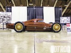 an antique race car on display in a building