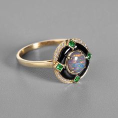 Elegant Black Opal, Diamond, and Tsavorite Engagement Ring with Black Agate in 18K Yellow Gold. Free Domestic USPS First Class Shipping! Free Gift Bag or Box with every order!Opal—the queen of gemstones, is one of the most beautiful gemstones in the world. Every piece of opal is unique in its own ways and patterns. We only use high-quality Natural Opals (NO synthetics or imitations) for our jewelry. ---------------------------------------------------------------------------------------------------- ABOUT THIS PRODUCT Solid 18K Yellow GoldAustralian Black Opal, 0.58 ct24 Diamond, 0.075 ct4 Tsavorite: 0.101 ctBlack AgateOpal Body Tone: N2Opal Brightness: B3Opal Size: 6 x 6 mmRing Size: 7Opal Color: Reflects Pink, Yellow, and Green Colors.Occasion: Engagement / Wedding ----------------------- Opal And Black Diamond Ring, Black Opal Ring Jtv, Witchy Engagement Ring, Tsavorite Engagement Ring, Opal Diamond Engagement Ring, Black Opal Engagement Ring, Black Opal Jewelry, Opal Promise Ring, Tsavorite Ring