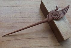 a wooden object that looks like a bird with wings on it