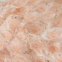 pink roses with gold sequins on them are arranged in an intricately designed pattern