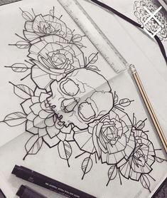 some flowers and pencils sitting on top of a piece of paper