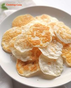 a white plate topped with chips on top of a table