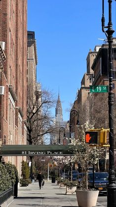 the street sign is clearly visible for all to see on this city street, as well as many buildings