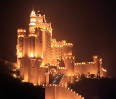 a castle lit up at night with lights on it