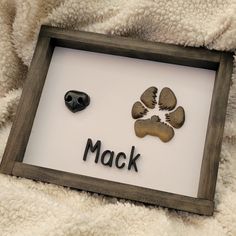 a dog paw print with the word mack on it