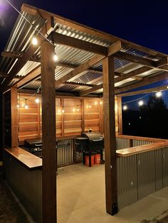 an outdoor bbq with lights and grilling area