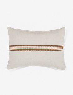 a white pillow with brown stripes on it