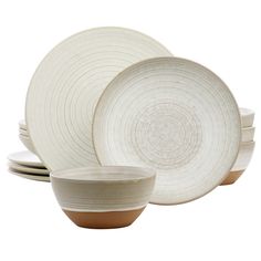 a set of white dishes with brown rims