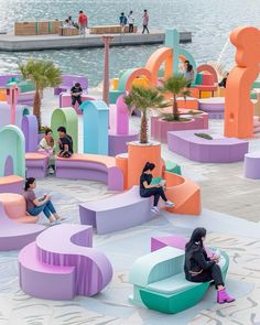 people are sitting on colorful benches near the water