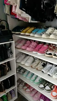 a closet filled with lots of shoes and handbags