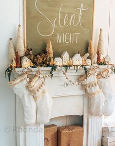 stockings hanging from the mantel in front of a chalkboard that says silent night