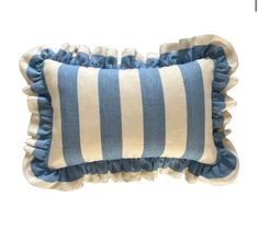 a blue and white striped pillow with ruffled edges