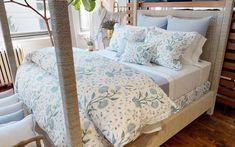 a bed with blue and white comforters in a bedroom