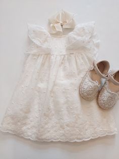 Elevate your baby girl's summer wardrobe with this stunning off-white Mayoral dress. The knee-length dress is made with embroidered lace fabric and features flutter sleeves, making it perfect for your little one's playtime or a dressy occasion.  This NWT dress is suitable for babies aged 9 months, making it a perfect addition to their wardrobe for the warmer months. The dress is ideal for a variety of events, and the embroidered lace fabric adds a touch of elegance that will make your baby girl stand out. cotton blend dress, 100% cotton lining. White Lace Dress For Baptism In Spring, White Lace Dress For Spring Baptism, Short Sleeve Embroidered Dress For Baptism, Summer Cotton Dresses With Scalloped Lace, Summer Cotton Dress With Scalloped Lace, Short Sleeve Lace Dress For Dress-up, Short Sleeve Lace Dress For Dress-up Occasions, Lace Dress With Short Sleeves For Dress-up, Off White Lace Dress With Ruffles