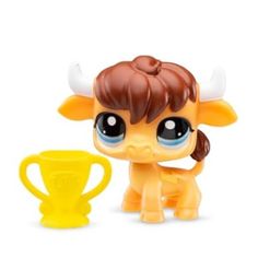 the littlest pet shop toy is in front of a cup and has horns on it