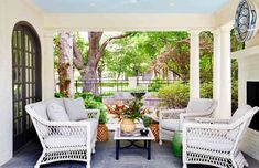 an outdoor living area with wicker furniture