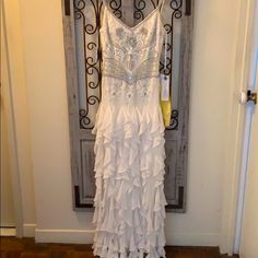 a white dress hanging on a door