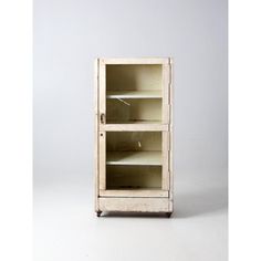 an old wooden cabinet with glass doors on the front and bottom shelves, against a white background