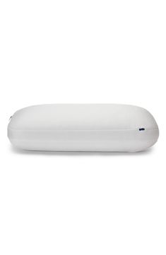 a white pillow sitting on top of a white surface