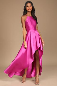 a woman wearing a pink dress with high low slits and an asymmetrical skirt