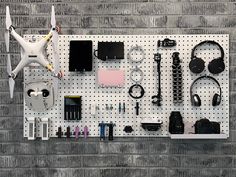 a wall mounted on a pegboard with electronics and gadgets