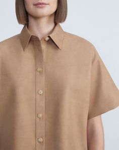 A study in understated luxury, this waist-cropped buttoned shirt is precisely tailored from light, buttery Italian nubuck calfskin suede. The sculptural silhouette is defined by dropped shoulders, which meet the pointed A-line sleeves in structured, nuanced folds.Shop all Blouses Summer Neutrals, Buttoned Shirt, Denim Suit, Understated Luxury, Sweater Sale, Jacket Sale, Blazer Coat, Skirts For Sale, Jacket Dress