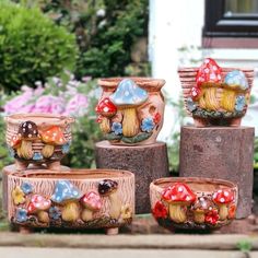 there are many small pots that have mushrooms on them in the garden, and one is made out of wood