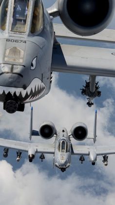 an airplane flying in the sky with its mouth open