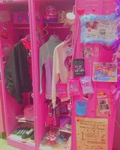 a pink locker with clothes and other items on it's shelves in a room