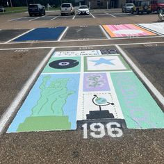 a parking lot painted with various colors and symbols