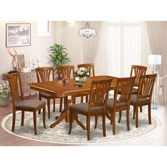 a dining room table and chairs with a rug on the floor