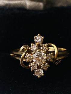 an antique diamond cluster ring in yellow gold