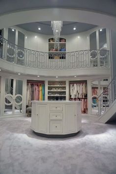 the inside of a closet with stairs and chandelier in it's center