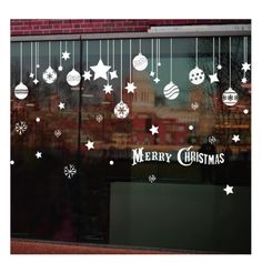 a window with christmas decorations on it and the words merry christmas written in large letters