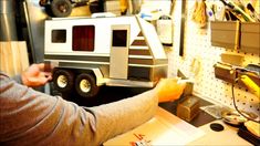 a man is working on a toy truck