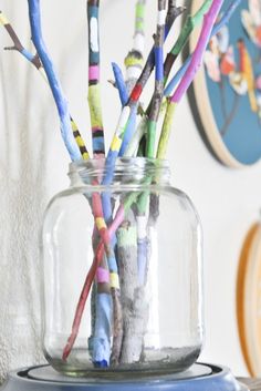 there are many colorful sticks in the jar