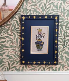 a blue frame hanging on the side of a wall