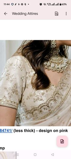 an image of a woman wearing a white sari with gold jewelry on her neck